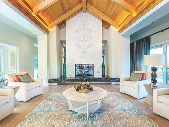 A custom fabricated book-matched porcelain slab fireplace is the centerpiece of the main living area; an exterior shot of Skyscape shows off the impressive architectural skills of the Parker Design Group; the front entrance was rebuilt to add windows and steel framed glass entry doors